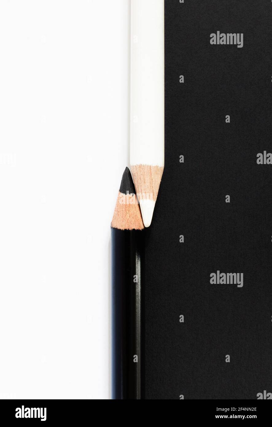 Black And White Pencils Against Contrasting Background To Illustrate Racial Diversity Concept Stock Photo