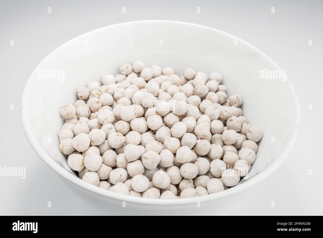 White chickpeas standing in white bowl Stock Photo