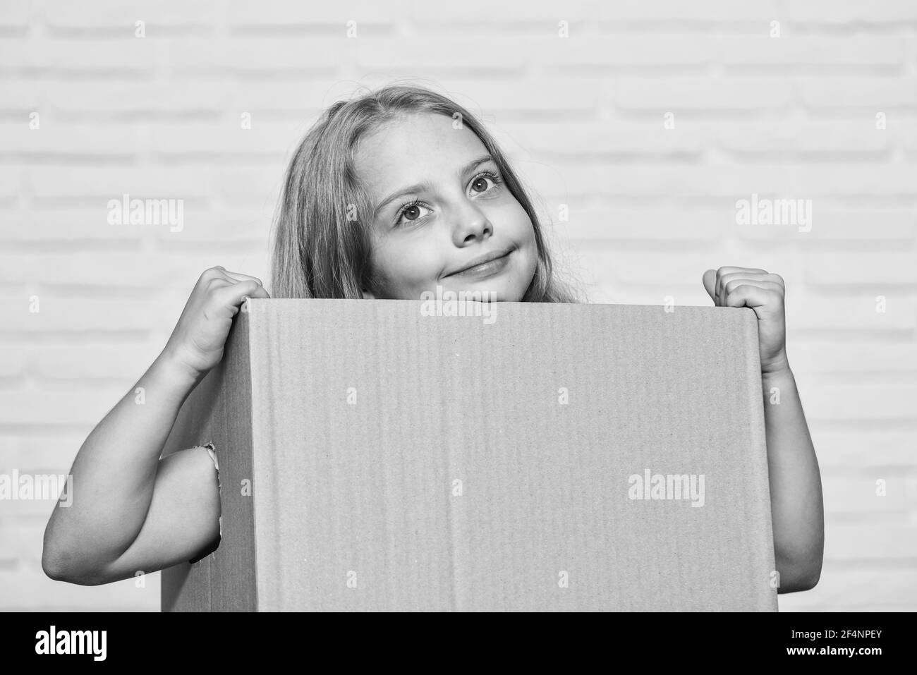 Make moving easier. Girl small child carry cardboard box. Move out