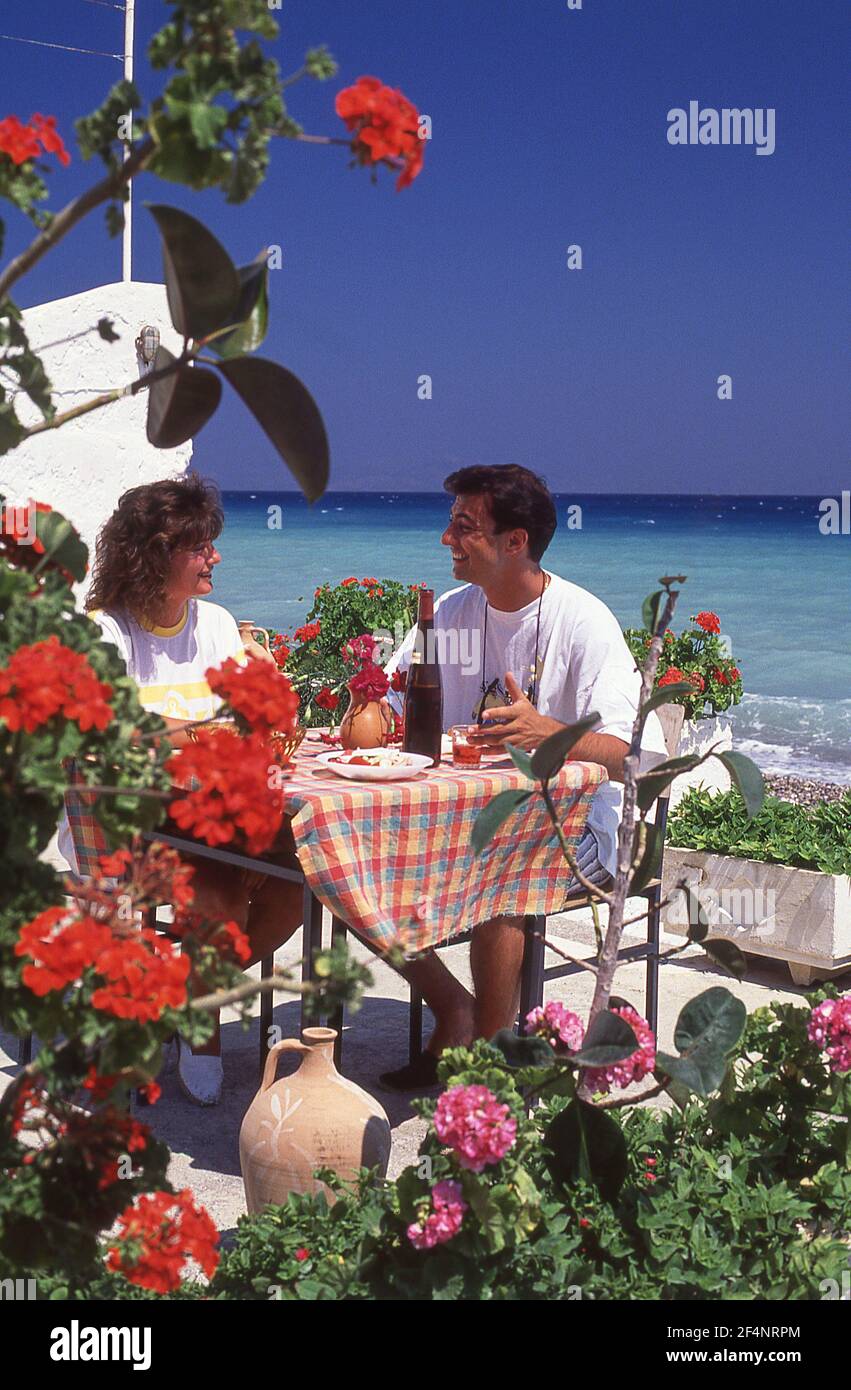 Couple eating at outdoor restaurant, Skiathos, Greek Islands, Greece Stock Photo