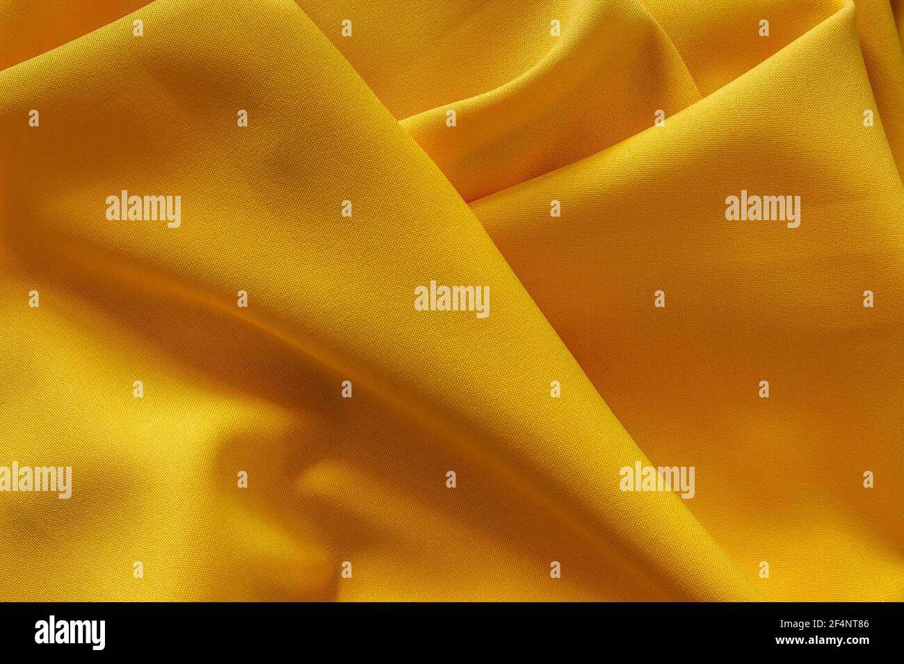Yellow fabric texture.Spring color.Abstract yellow background. Smooth elegant golden textile. Trendy Color of the Year 2021. Color of happiness, glory Stock Photo