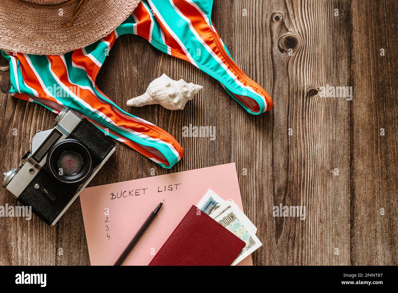 Travel concept banner flat lay.Items for summer vacation: passport,swimsuit,hat,money,vintage camera copy space.Top view holiday concept.Planning fun Stock Photo