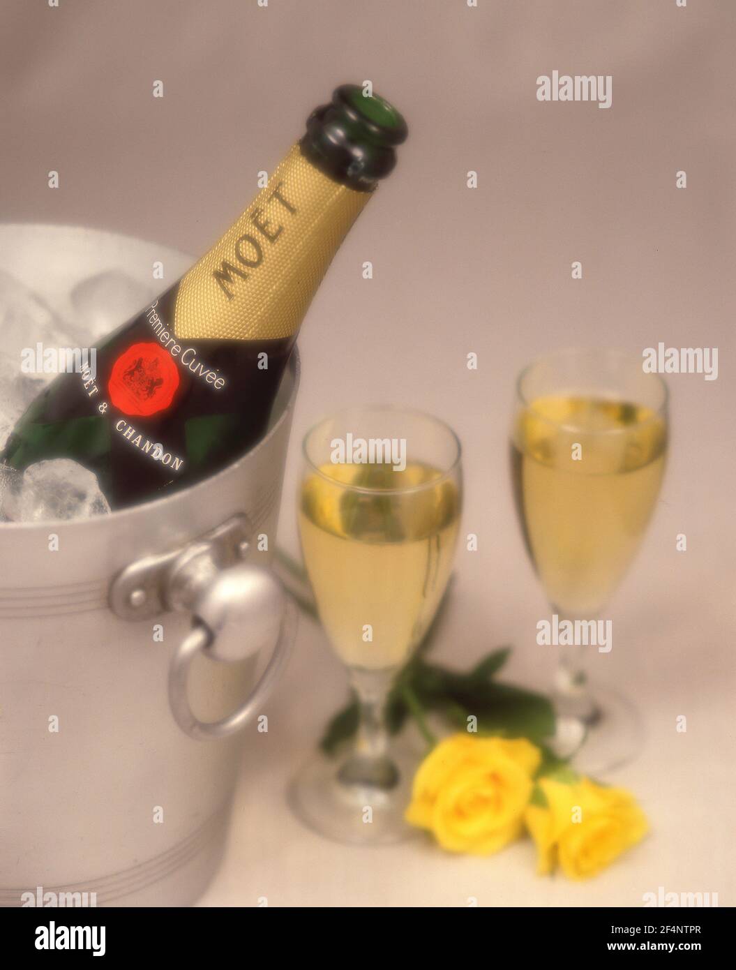 Moët & Chandon champagne in ice-bucket with yellow roses and crystal glasses, Greater London, England, United Kingdom Stock Photo