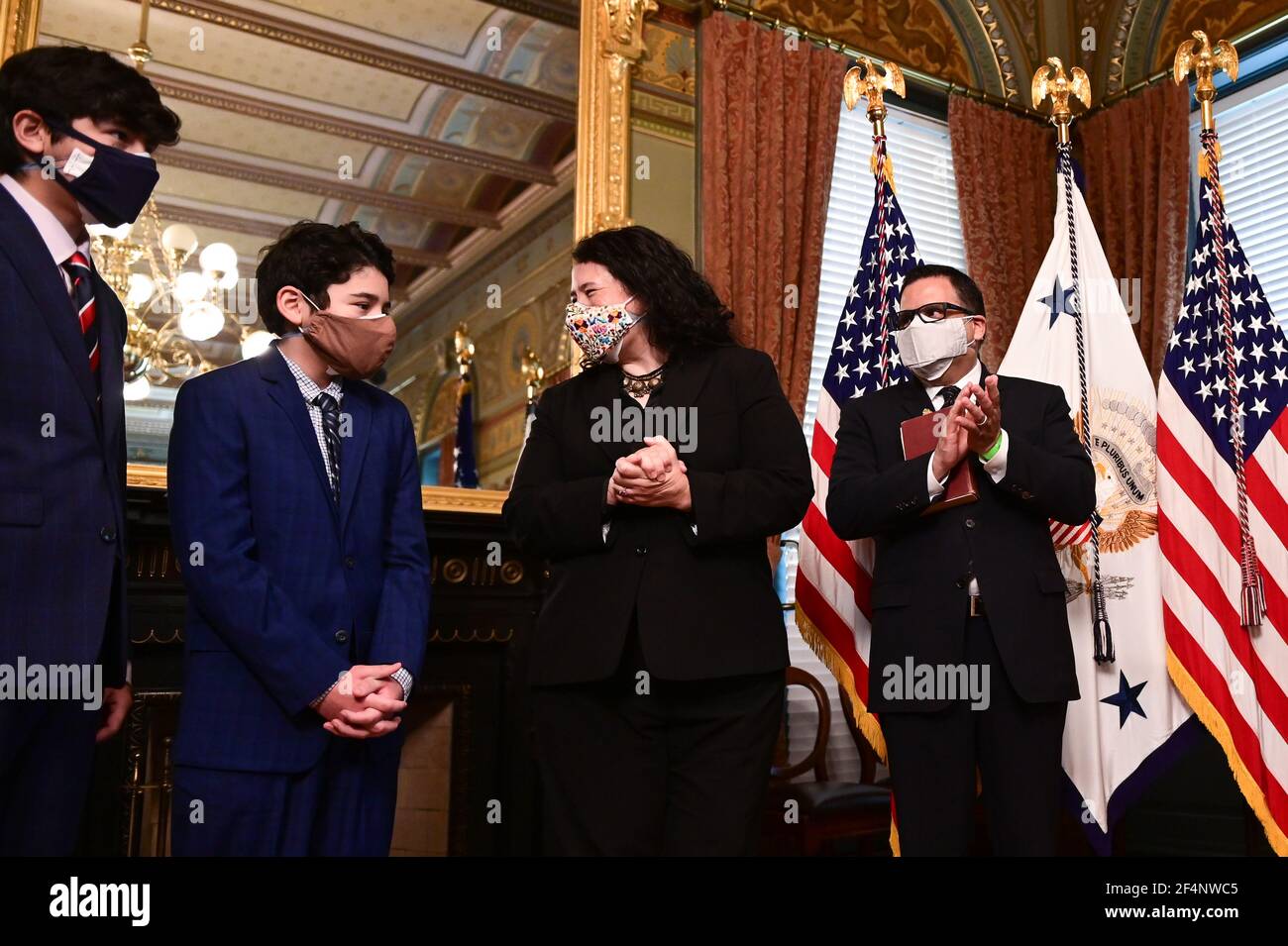 Isabel Guzman, administrator of the U.S. Small Business Administration (SBA), reacts with her husband, Javier Guzman, and sons, Cortez Guzman and Cruz Guzman after being sworn in by U.S. Vice President Kamala Harris during a ceremony in the Eisenhower Executive Office Building in Washington, DC, U.S., on Monday, March 22, 2021. Guzman served as a deputy chief of staff and senior adviser to the administrator at the SBA during the Obama administration, and has run her own small businesses. Credit: Erin Scott/Pool via CNP /MediaPunch Stock Photo