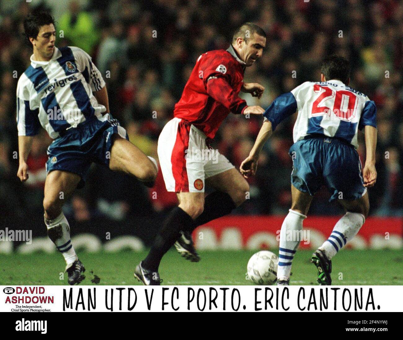 Eric Cantona takes the ball past players for F.C. Porto during the Manchester United V F.C. Porto UEFA Cup match at the Old Trafford Stock Photo