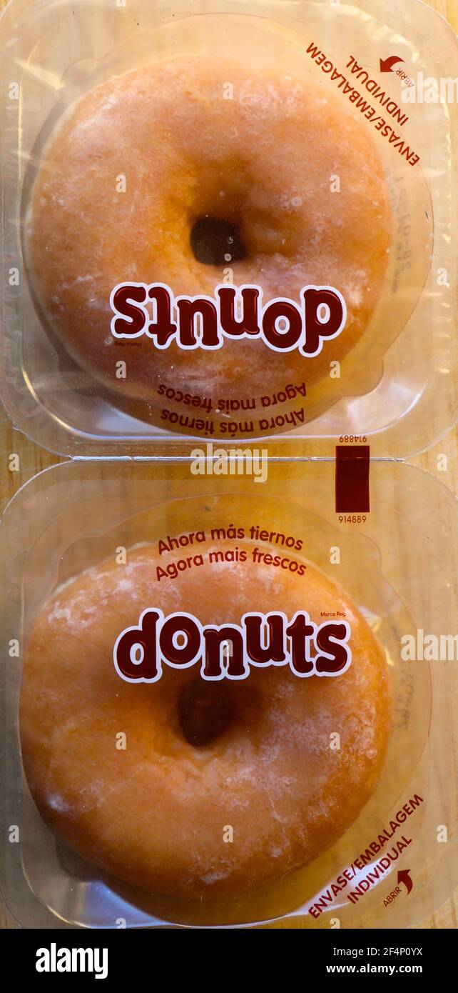 Photo of Two plain unhealthy sugary round Spanish doughnuts individually wrapped in plastic easy open packaging seen from above Stock Photo