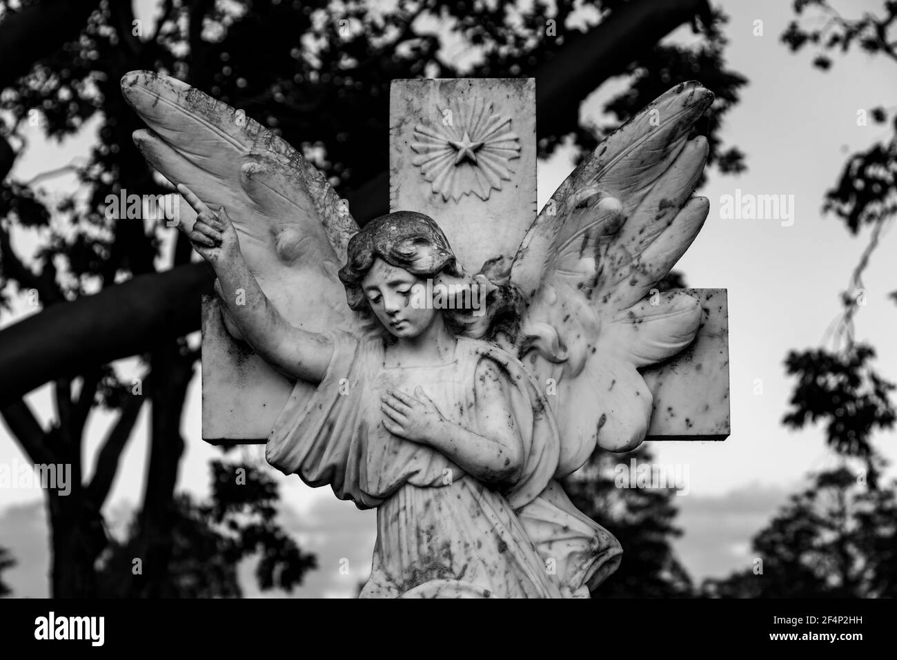 Angel on a cross black and white Stock Photo