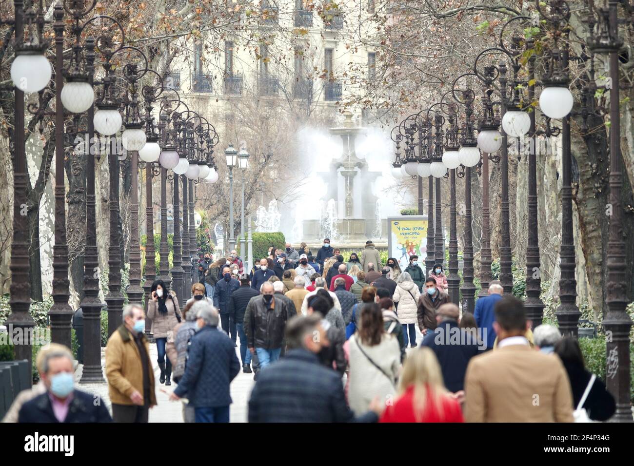 Many people with masks walking through the "Carrera de la Virgen" in Granada  (Spain), a beautiful park in the center of the city surrounded by trees  Stock Photo - Alamy