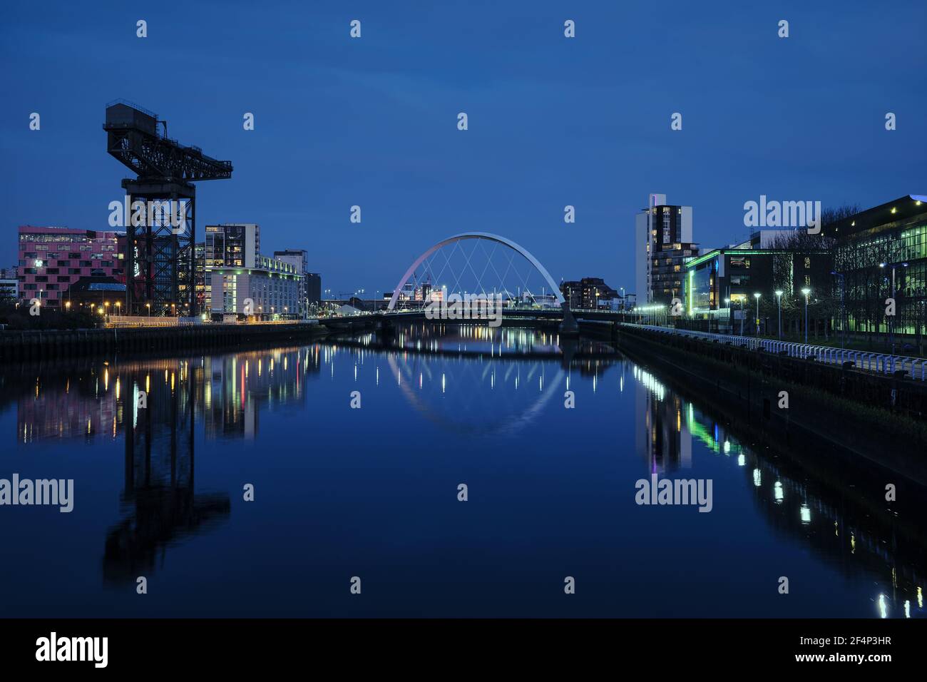 Night view of the Clyde Arc or Squinty Bridge from the East and river Clyde, Glasgow, Scotland Stock Photo