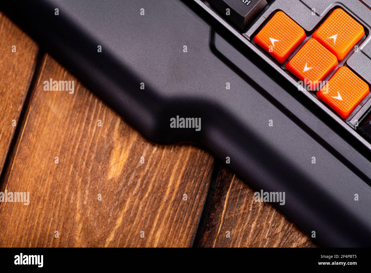 Orange arrow keys on a black keyboard, up, down, left, right buttons on ...