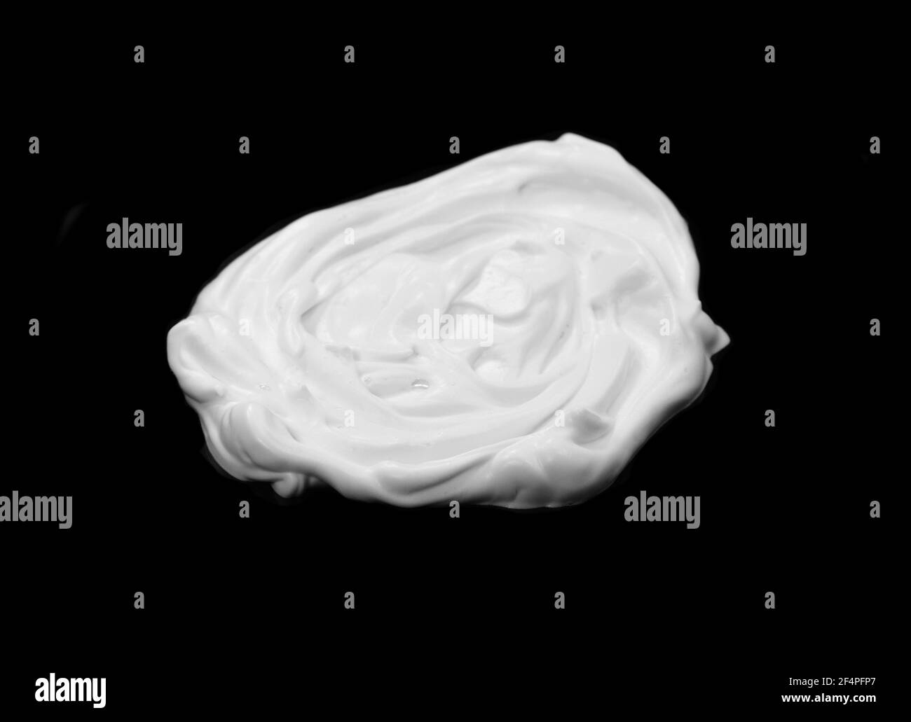 whipped cream or meringue isolated on black background. Stock Photo