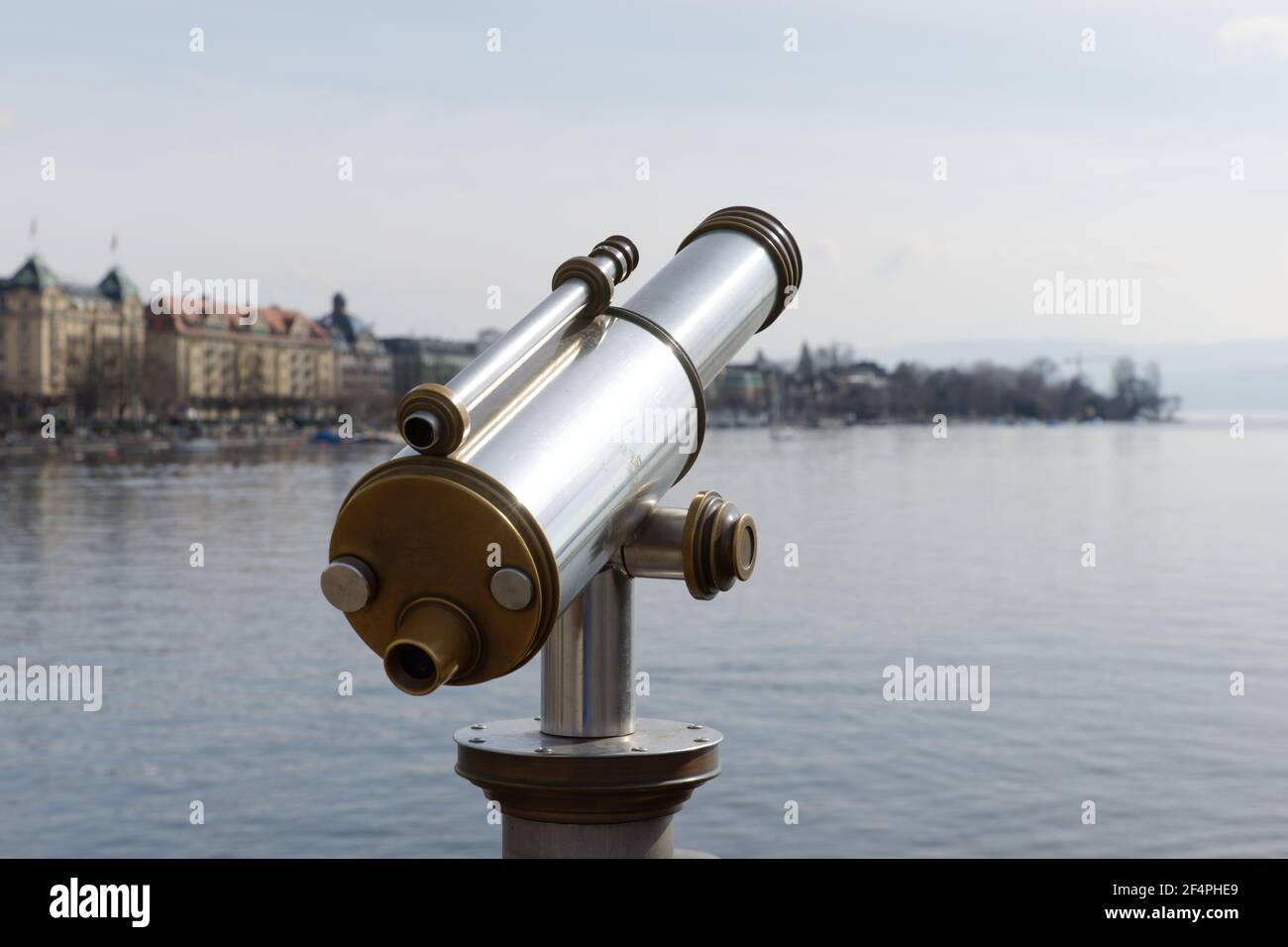 antiques old interesting observation platform binoculars for city and landscape sightseeing made of metal and golden copper, by day, without perons Stock Photo