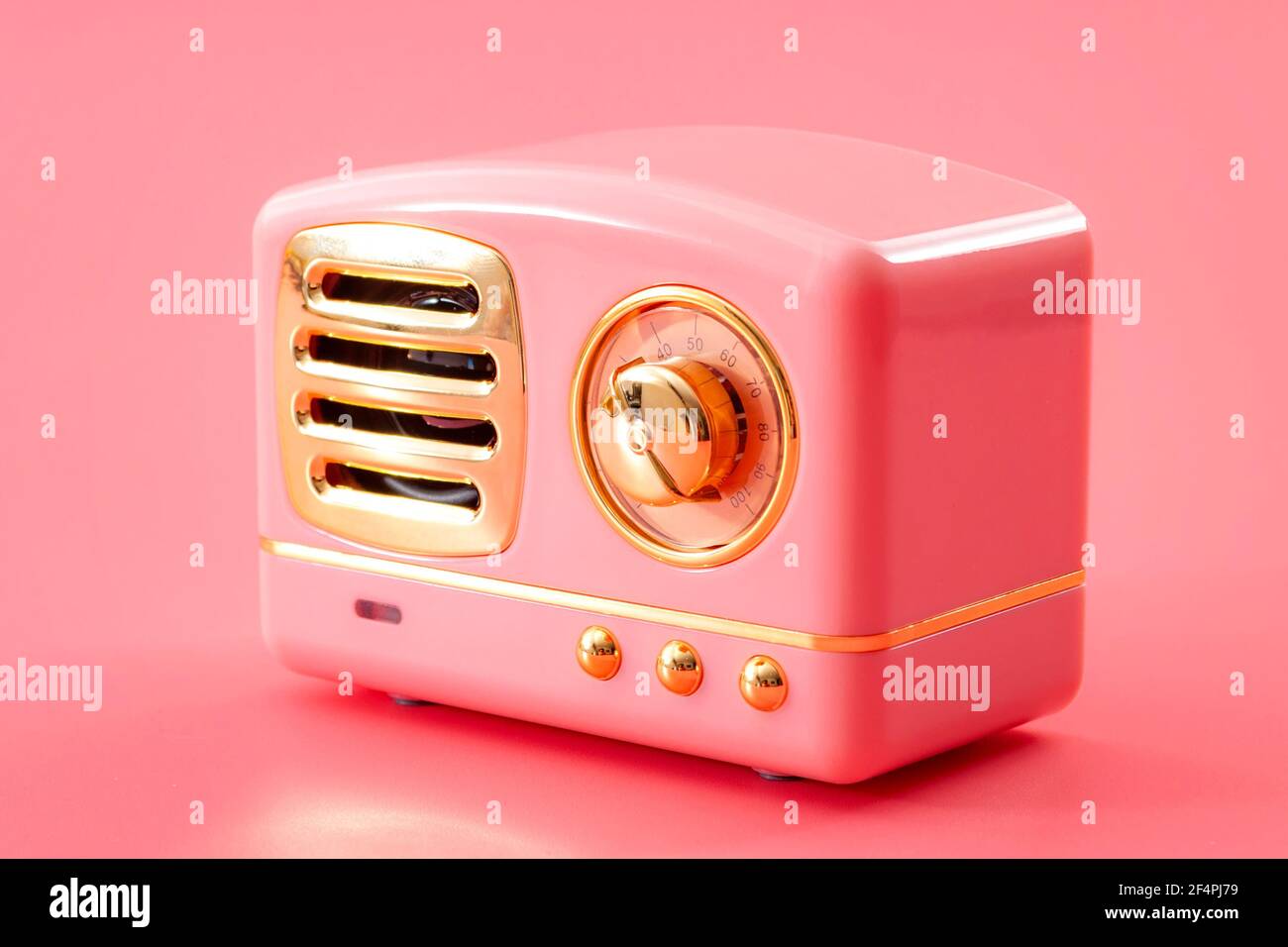 Vintage technology, 70s audio equipment and live music sound system concept theme with retro radio tuner with metal chrome knob isolated on pink backg Stock Photo