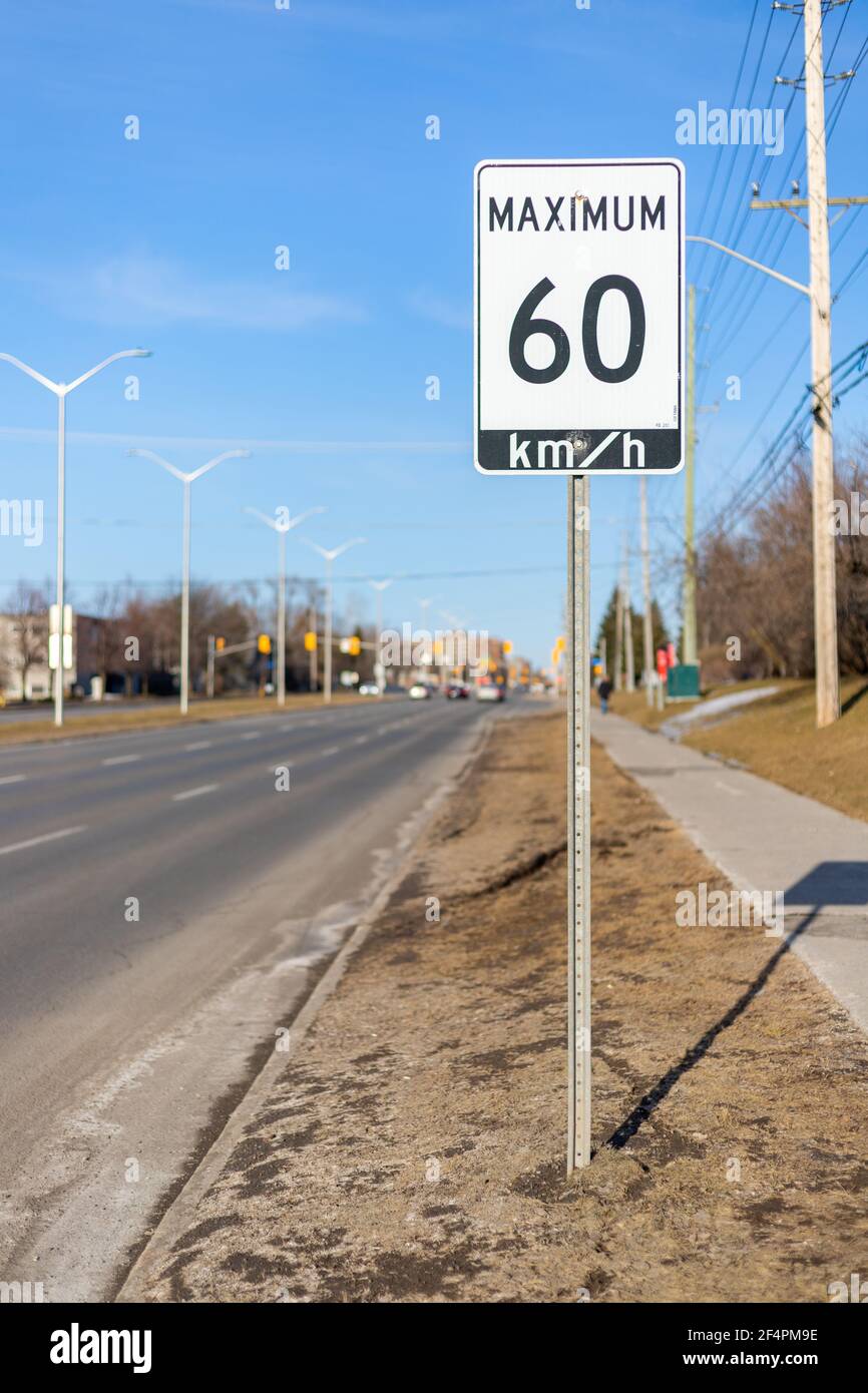 Ottawa, Canada - March 19, 2021: Speed limit road sign, 60 km h maximum Stock Photo