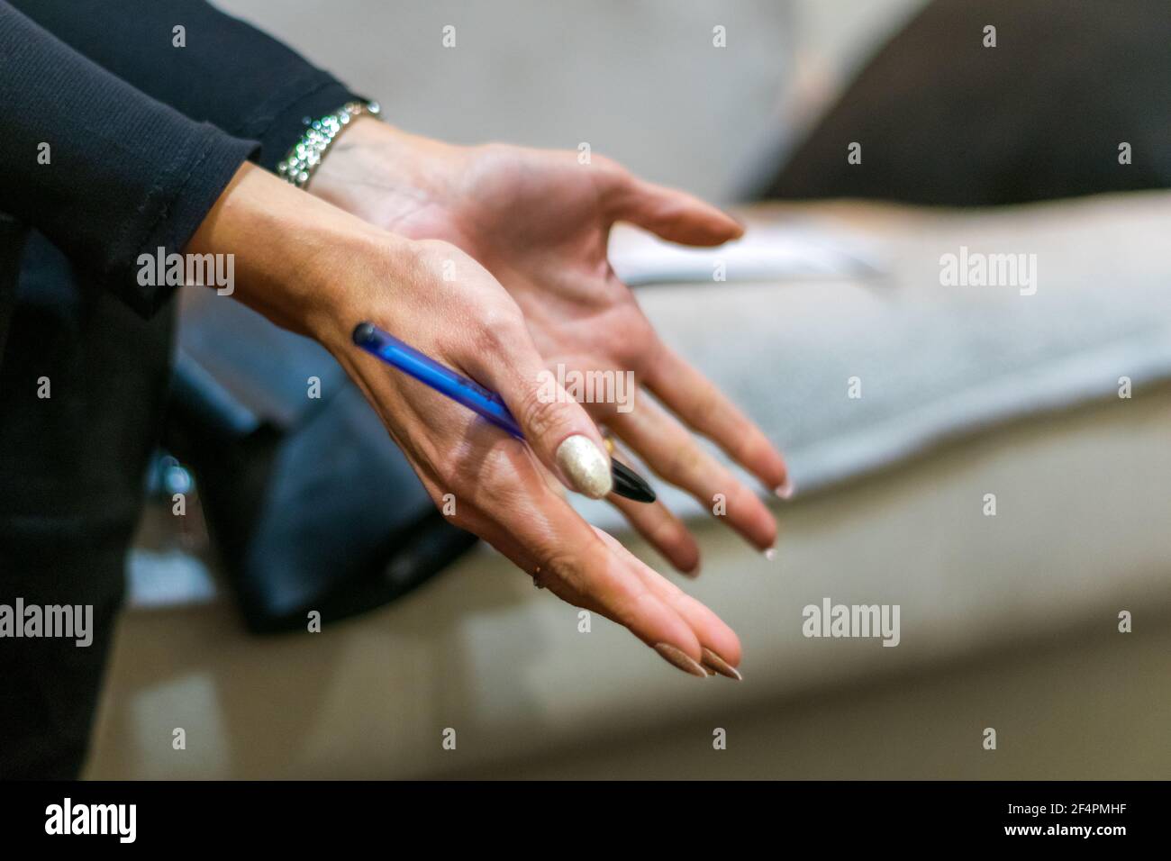 Women's world, women explaining or teaching with a pen in the  right hand. Women showing knowledge to someone, leadership. Stock Photo