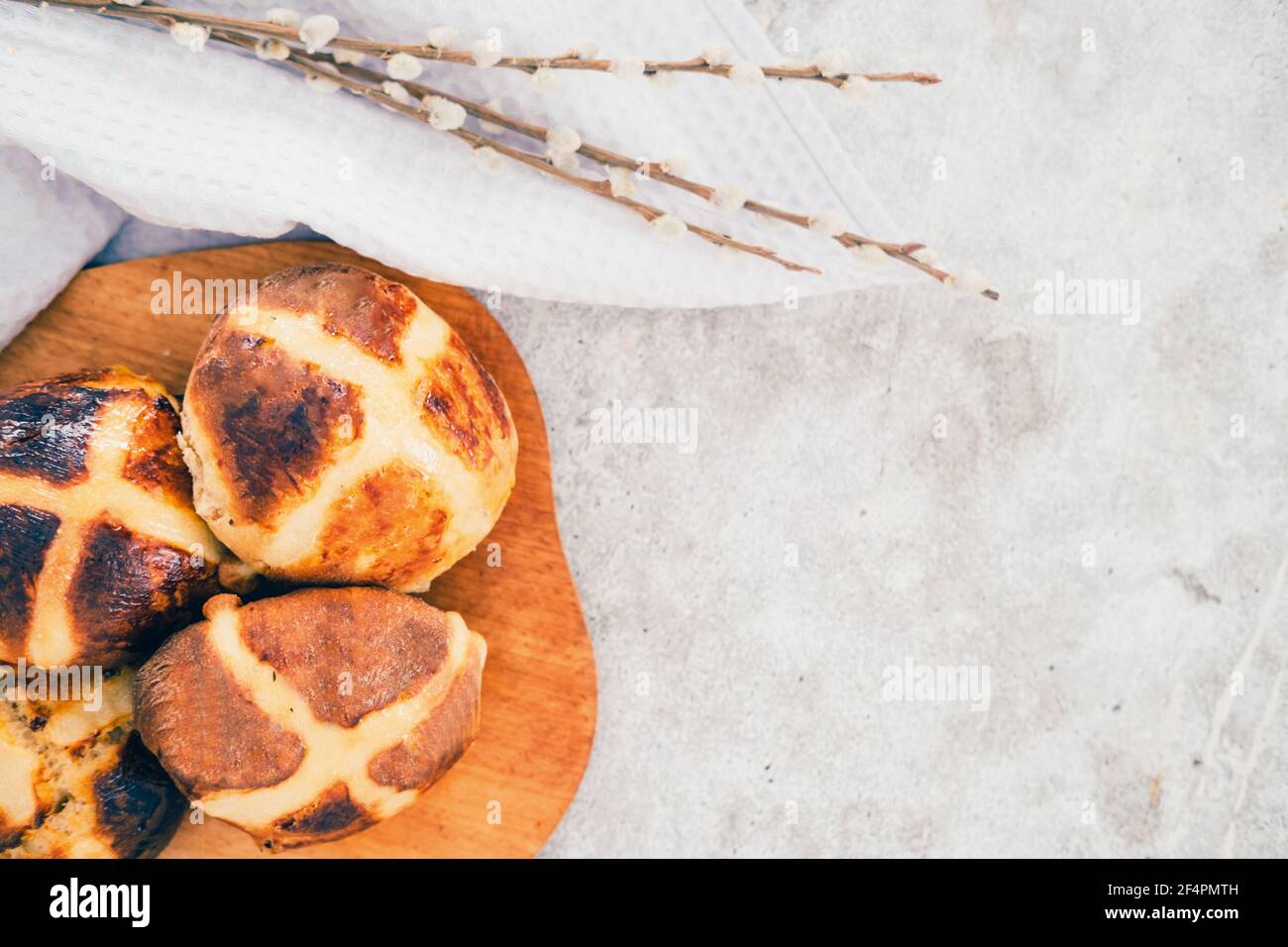 Traditional British Easter buns on a wooden plank. Stock Photo