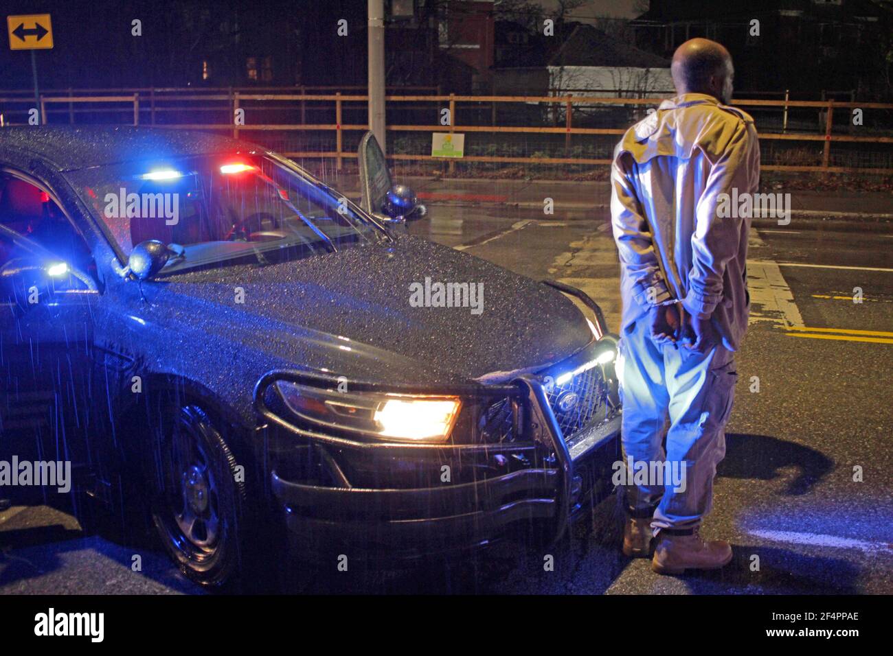 A man is handcuffed and detained by police in Detroit, Michigan, USA Stock Photo