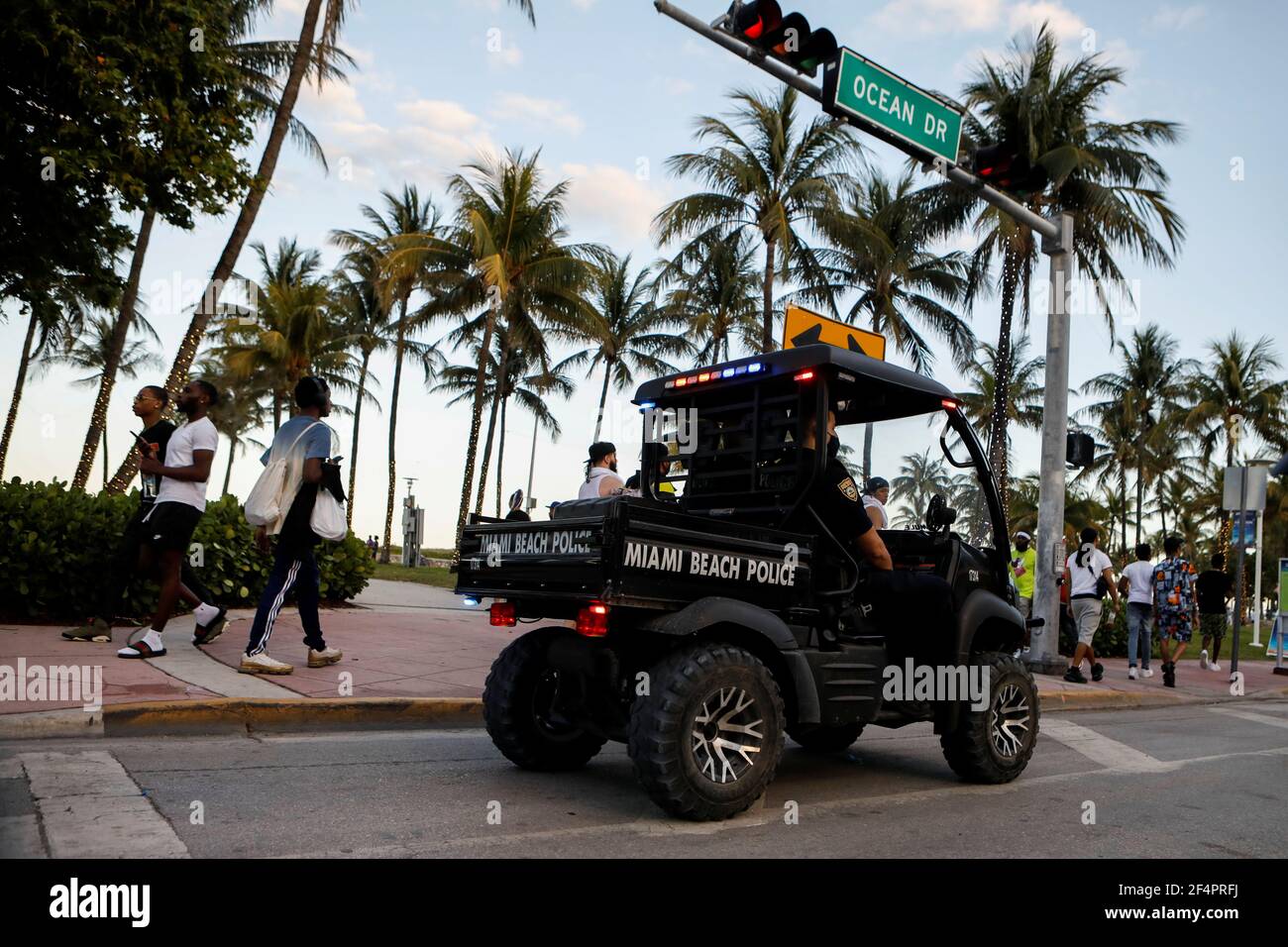 Police officers patrol Ocean Dr as revelers enjoy spring break festivities, amid the coronavirus disease (COVID-19) outbreak in Miami Beach, Florida, U.S., March 22, 2021. REUTERS/Marco Bello Stock Photo