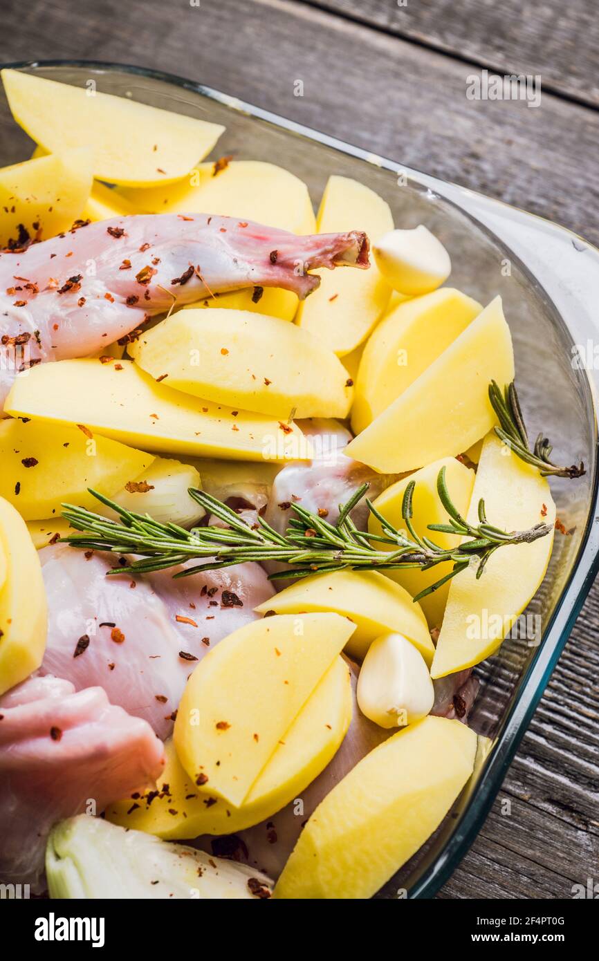 Raw rabbit meat marinated in glass bowl. Selective focus. Stock Photo