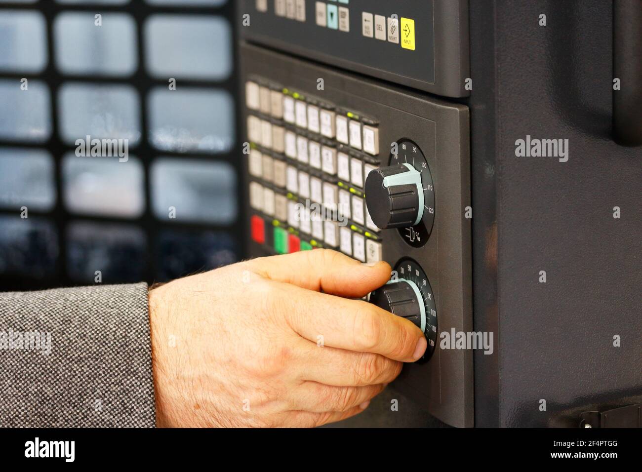 Engineer tunes parameters of CNC machine. CNC control panel closeup. Selective focus. Stock Photo