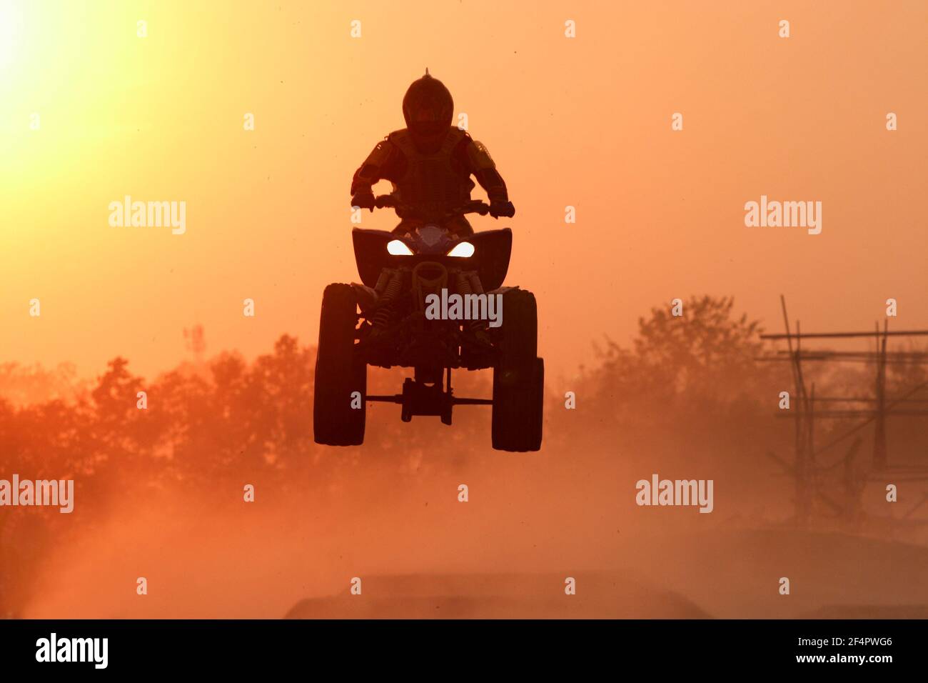 Quad bike Jump in the sunset Stock Photo