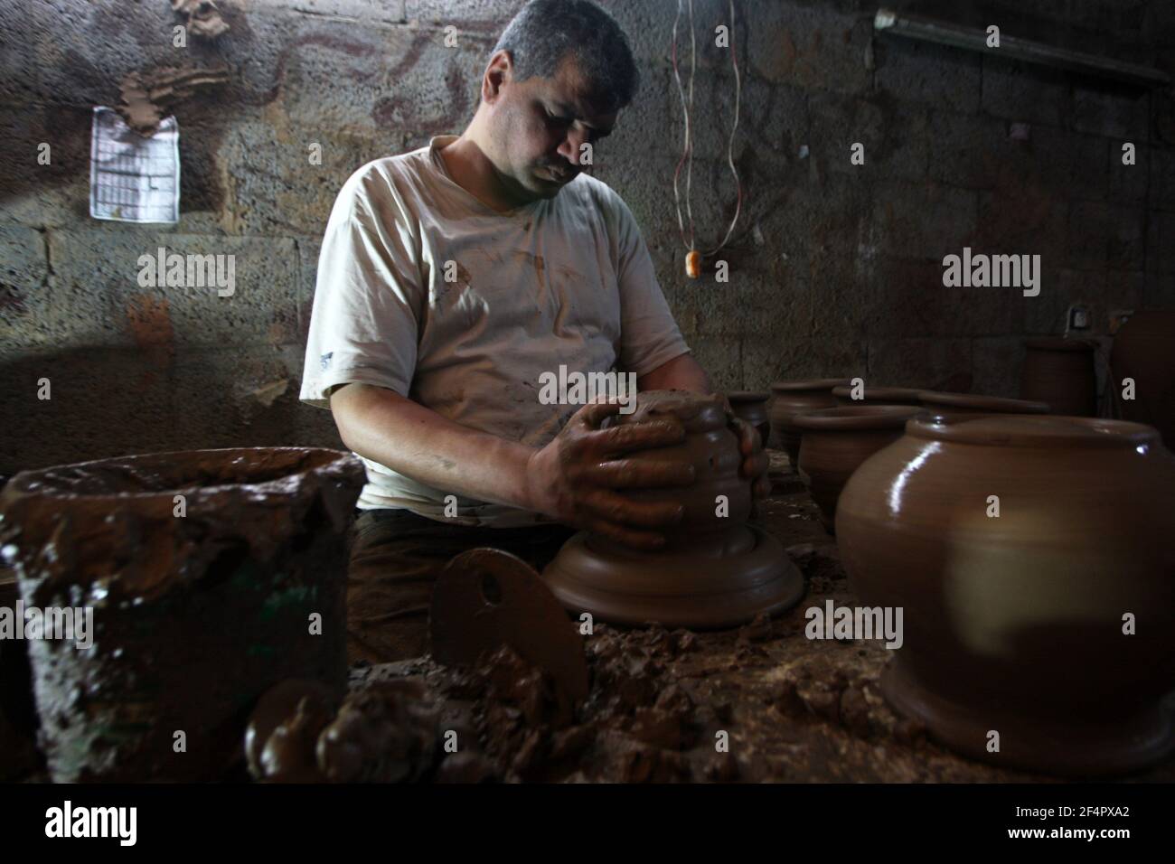 Deir Al Balah, Gaza. 22nd Mar, 2021. Palestinian potter Sid Atallah works at the family workshop in Deir al-Balah in the central Gaza Strip, on Monday, March 22, 2021. Photo by Ismael Mohamad/UPI Credit: UPI/Alamy Live News Stock Photo
