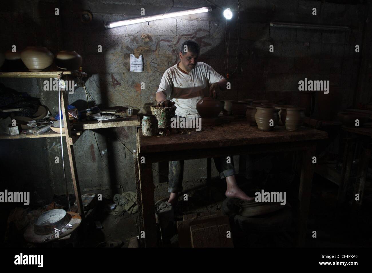 Deir Al Balah, Gaza. 22nd Mar, 2021. Palestinian potter Sid Atallah works at the family workshop in Deir al-Balah in the central Gaza Strip on Monday, March 22, 2021. Photo by Ismael Mohamad/UPI Credit: UPI/Alamy Live News Stock Photo