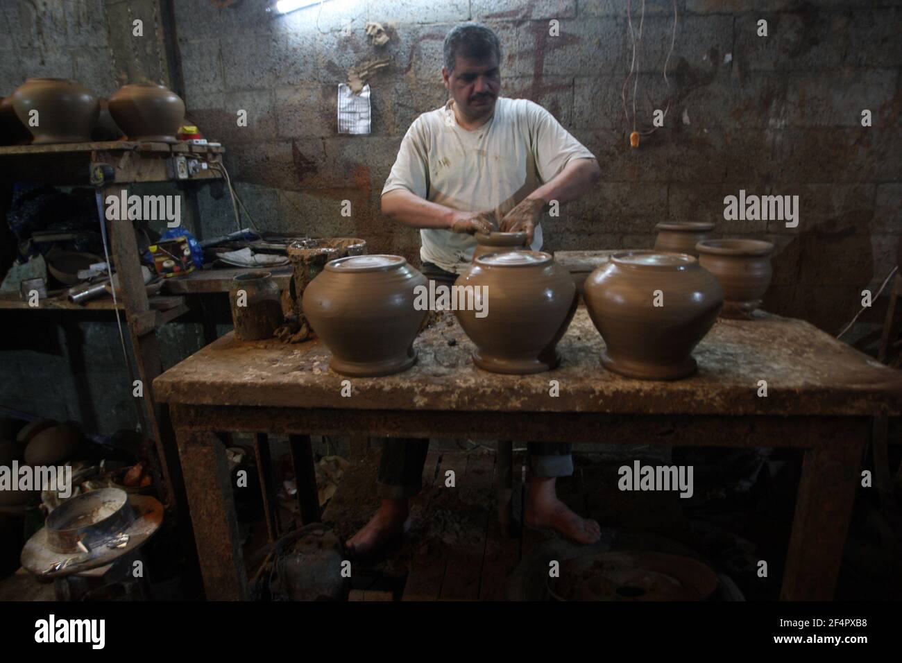 Deir Al Balah, Gaza. 22nd Mar, 2021. Palestinian potter Sid Atallah works at the family workshop in Deir al-Balah in the central Gaza Strip, on Monday, March 22, 2021. Photo by Ismael Mohamad/UPI Credit: UPI/Alamy Live News Stock Photo