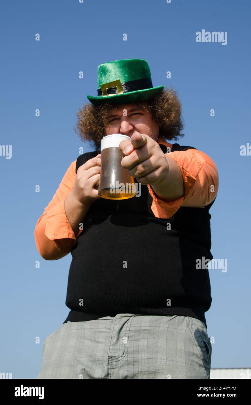 Funny fat guy is drinking beer. Stock Photo