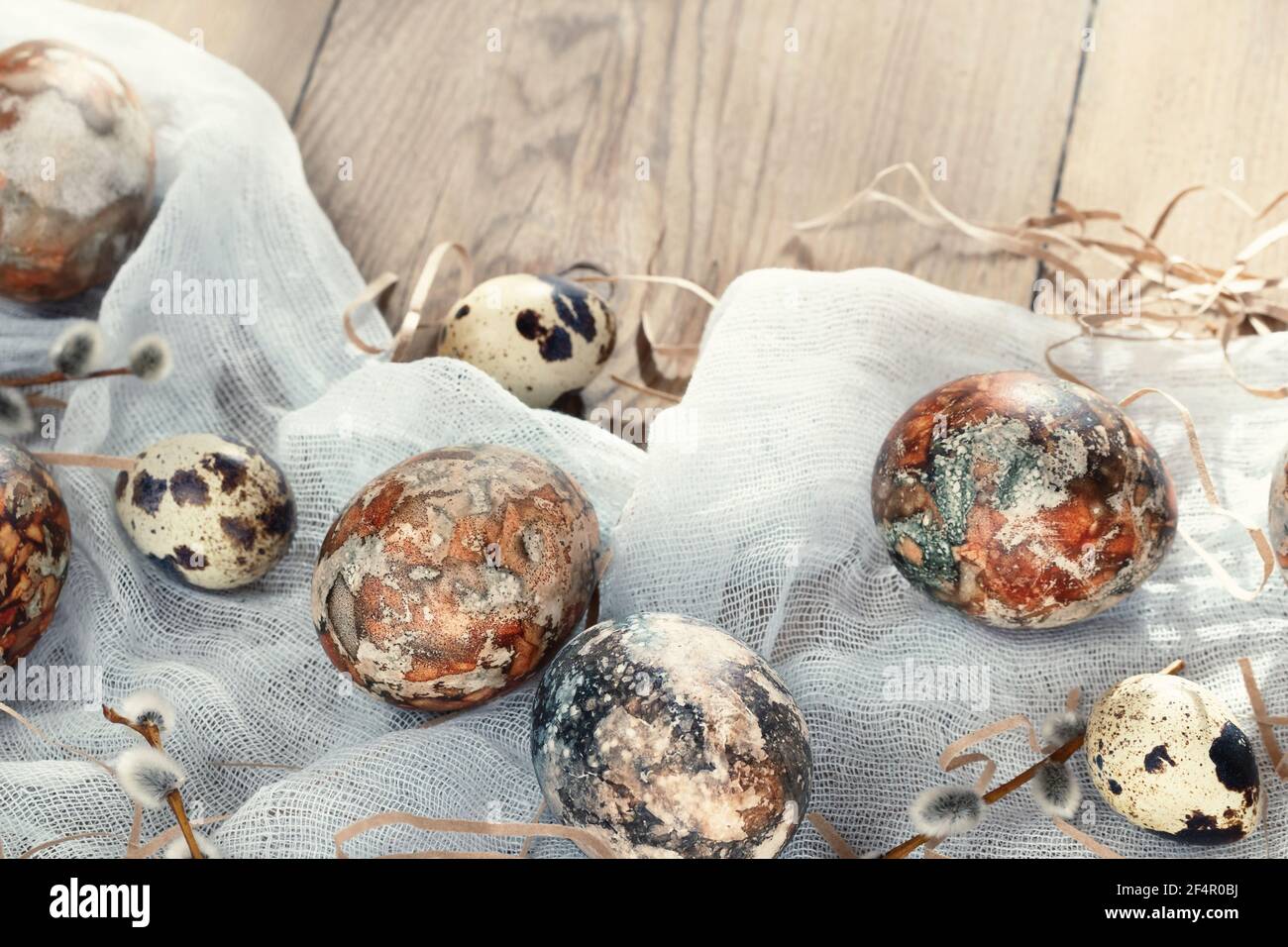 Easter composition - Easter eggs painted with natural dyes on a wooden table. Stock Photo