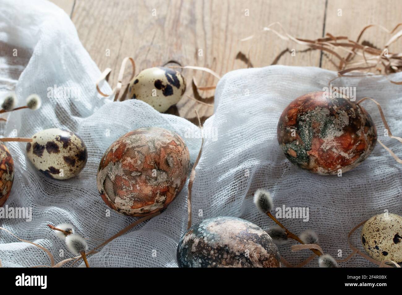 Easter composition - Easter eggs painted with natural dyes on a wooden table Stock Photo