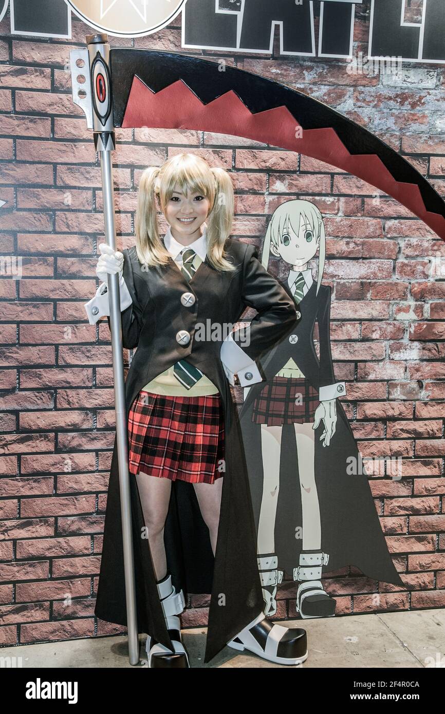 Japanese female dressed in as Maka Albarn with Soul Eater Scythe poses in  front of image of her anime character, Tokyo International Anime Fair,  Japan Stock Photo - Alamy