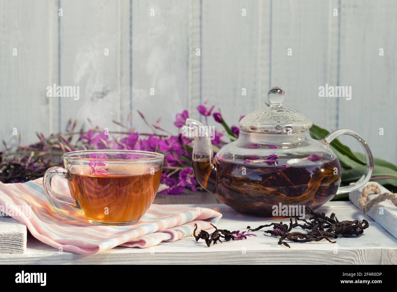 Herbal tea made from fireweed known as blooming sally in teapot and cup, copy space. Stock Photo
