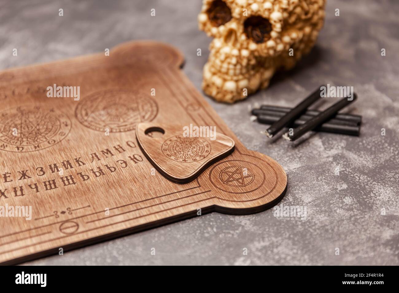 Mediumship divination equipment. Ouija board on grey background. Stock Photo