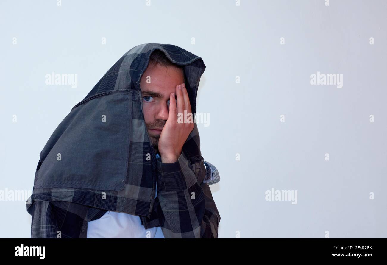 Spanish young bearded male with a flannel shirt over his head covering