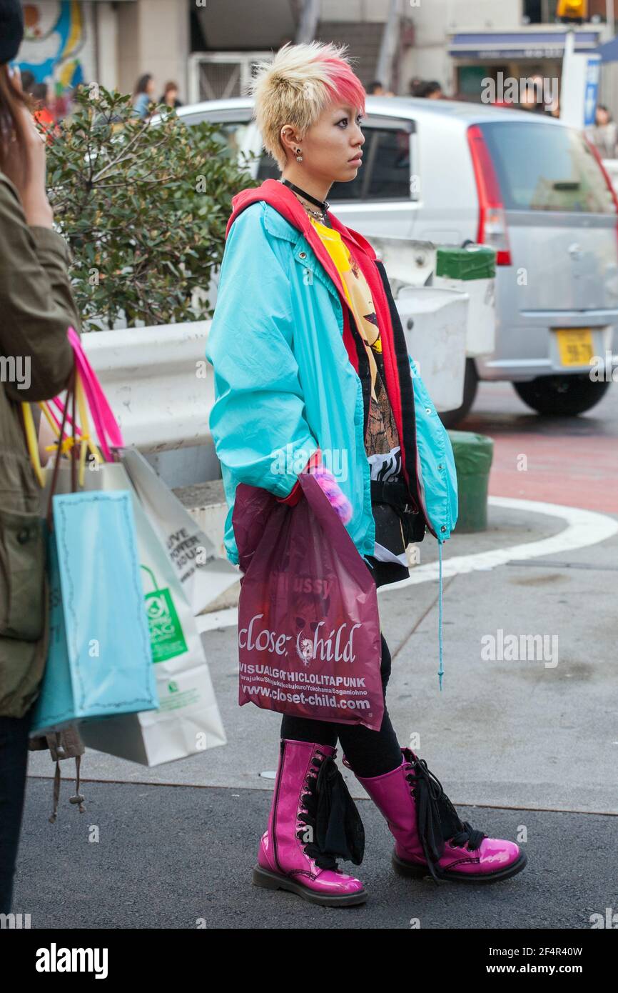 Japanese Street fashion in 2008: Pretty female dressed in colourful clothing, spiky blonde hair and pink Dr.Marten boots, Harajuku, Tokyo, Japan Stock Photo