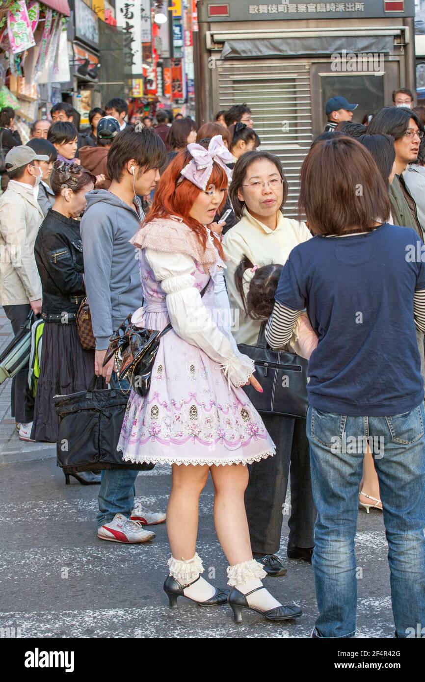 Japanese lolita stands waiting to cross road, Shinjuku, Tokyo, Japan Stock Photo