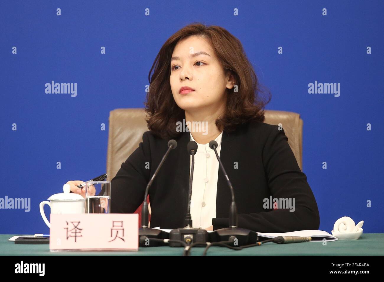 Female Chinese translator Zhang Jing interprets at a press conference