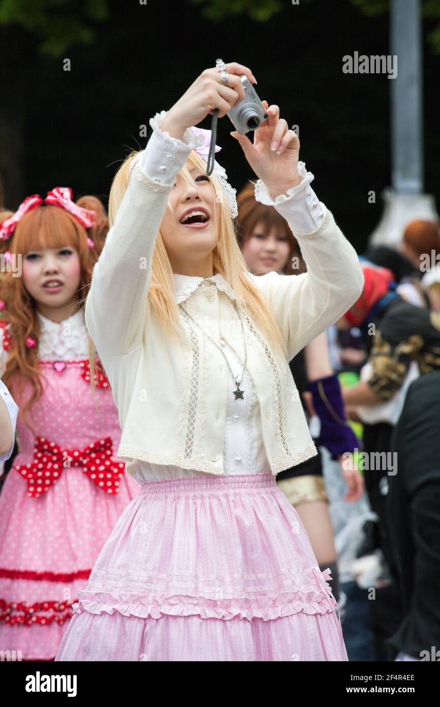 Photograph of pretty, smiling Japanese lolita taking a photo overhead with  her compact camera, Harajuku, Tokyo, Japan Stock Photo - Alamy