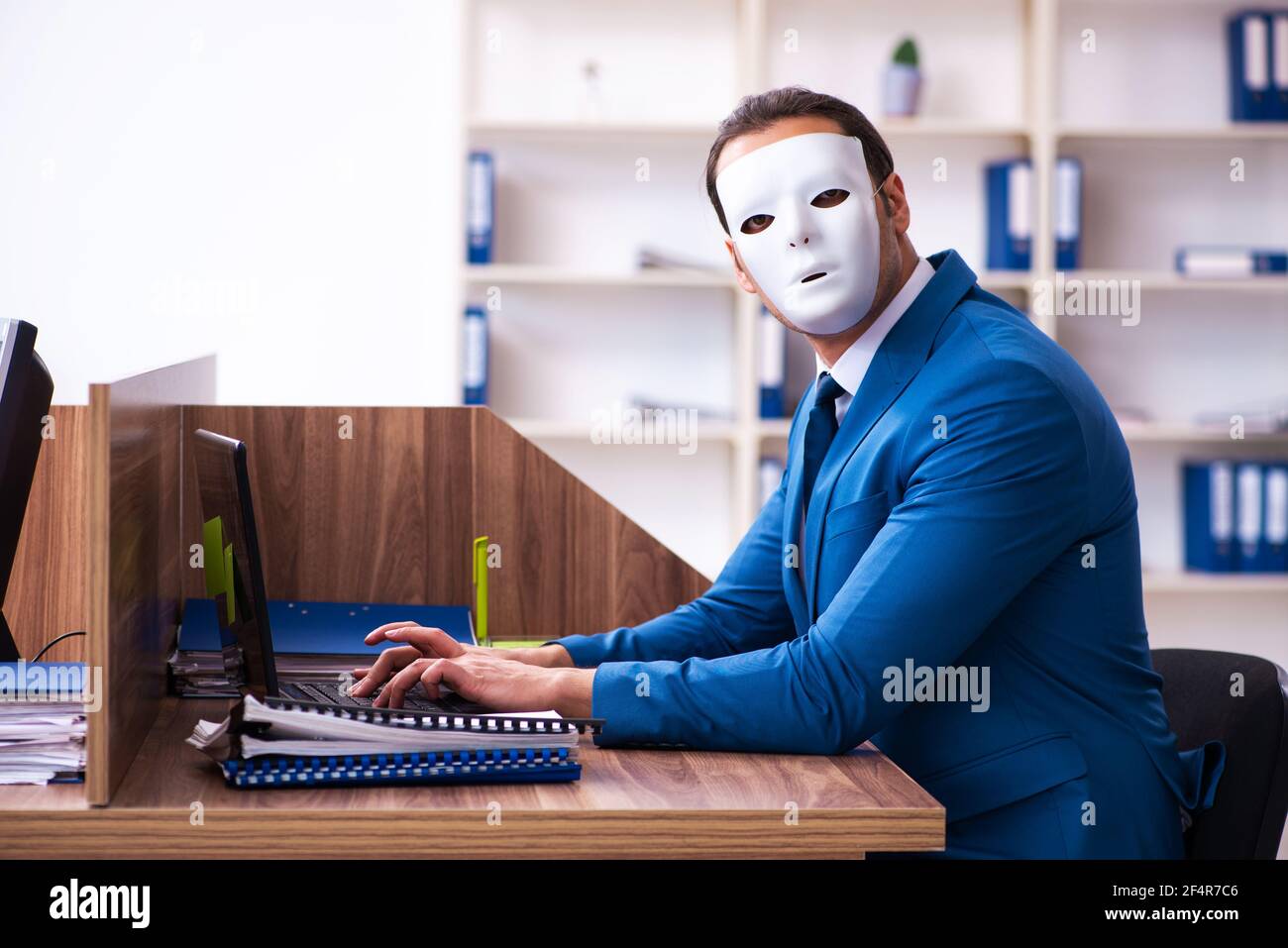Young employee wearing mask in the office Stock Photo - Alamy