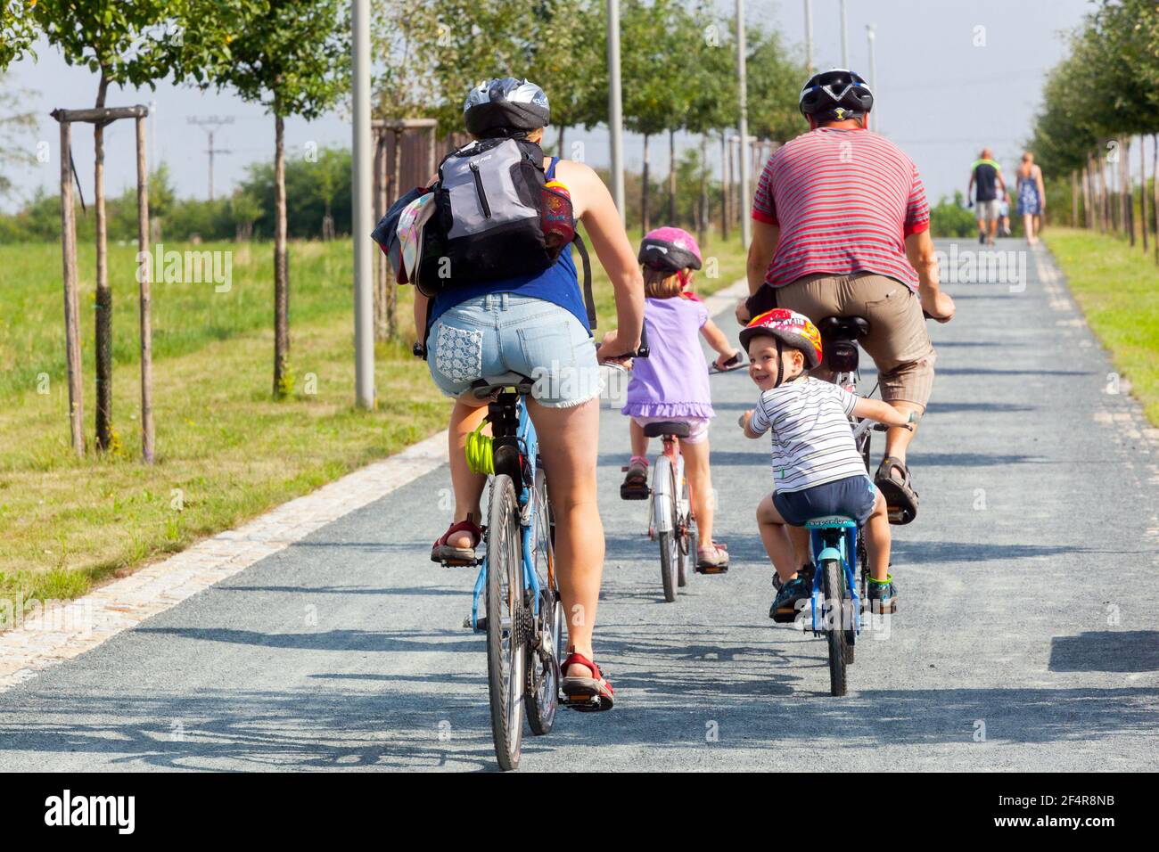 Family on bike rear view bicycle, Family out cycling children riding bikes Children on bike ride Stock Photo