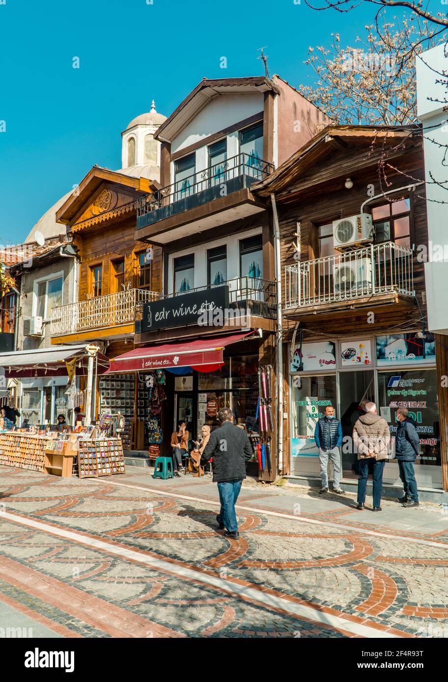 Edirne, Turkey - February 26, 2021 - street photography of people walking and traditional wooden houses with shops in downtown Edirne, Western Turkey. Stock Photo