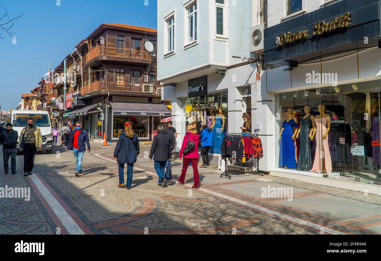 Edirne, Turkey - February 26, 2021 - street photography of people walking and traditional wooden houses with shops in downtown Edirne, Western Turkey. Stock Photo