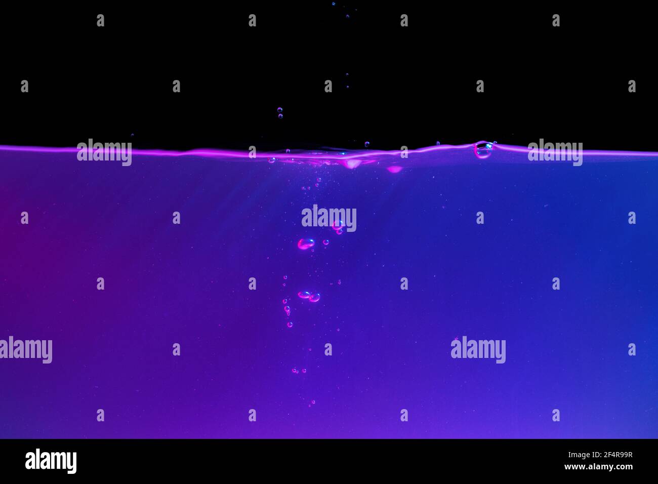 Neon purple water with a splash bubbles, background Stock Photo Alamy