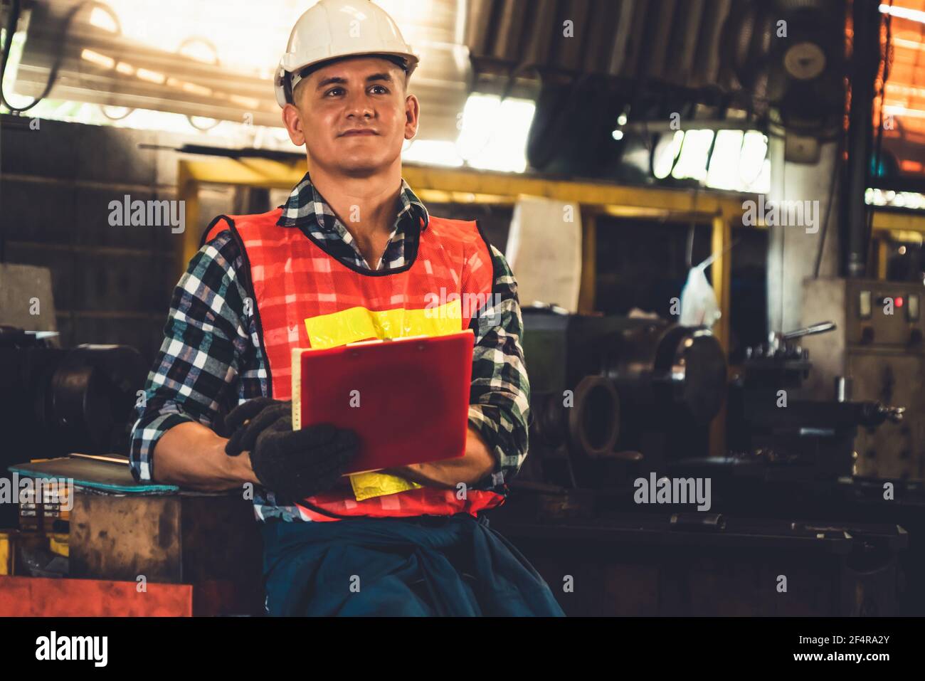 Manufacturing worker working with clipboard to do job procedure