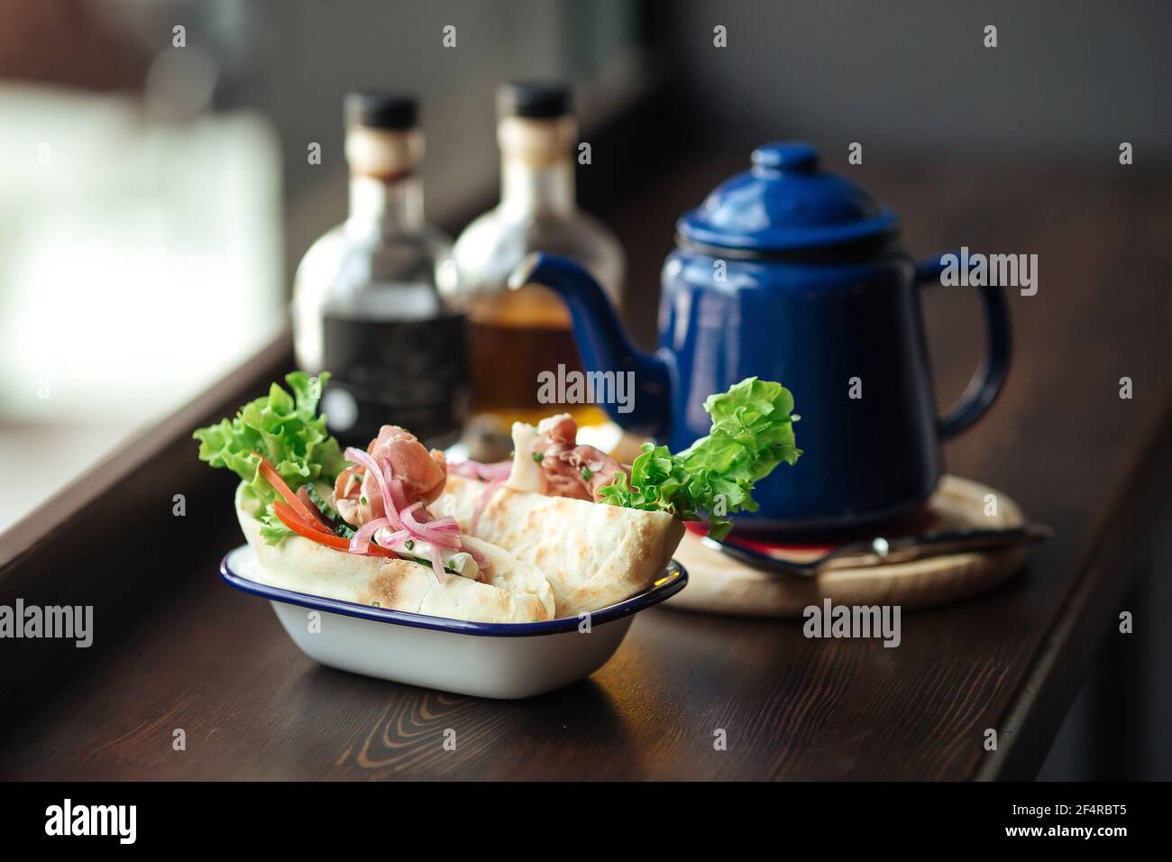 Pita sandwiches with kettle of coffee on cafe desk Stock Photo