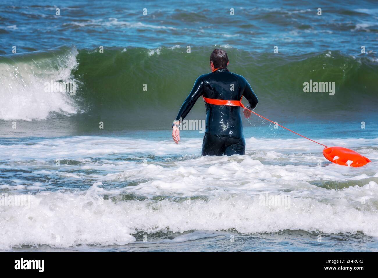 Lifeguard running to rescue a drowning person Stock Photo Alamy