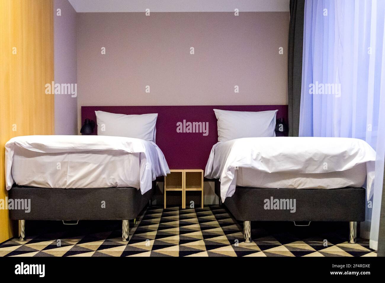 Hotel room with two double beds with pillows Stock Photo