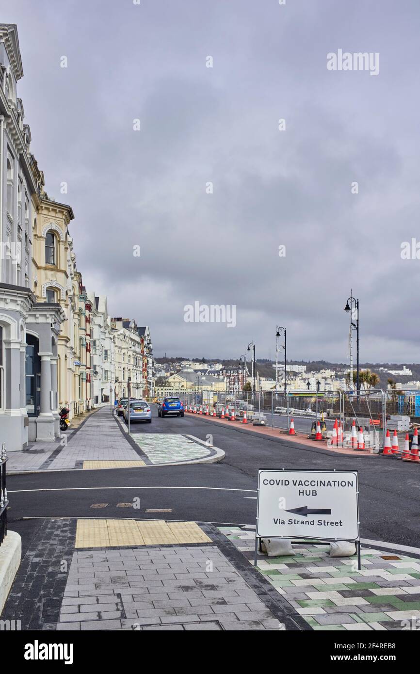 Covid vaccination hub signage on the promenade in Douglas, Isle of Man Stock Photo