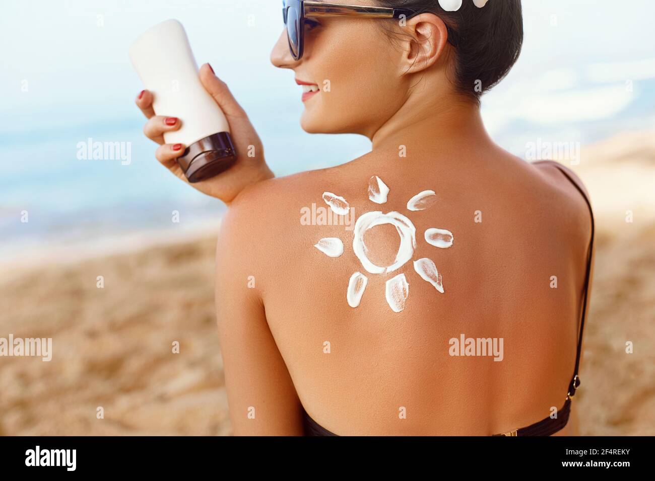 Skin Care Sun Protection Woman Apply Sun Cream Girl Holding Moisturizing Sunblock Woman With Suntan Lotion On Beach In Form Of The Sun Portrait O Stock Photo Alamy